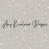 The logo "Amy Kneeland Designs" appears over a eucalyptus leaf pattern in olive greens and mauves.